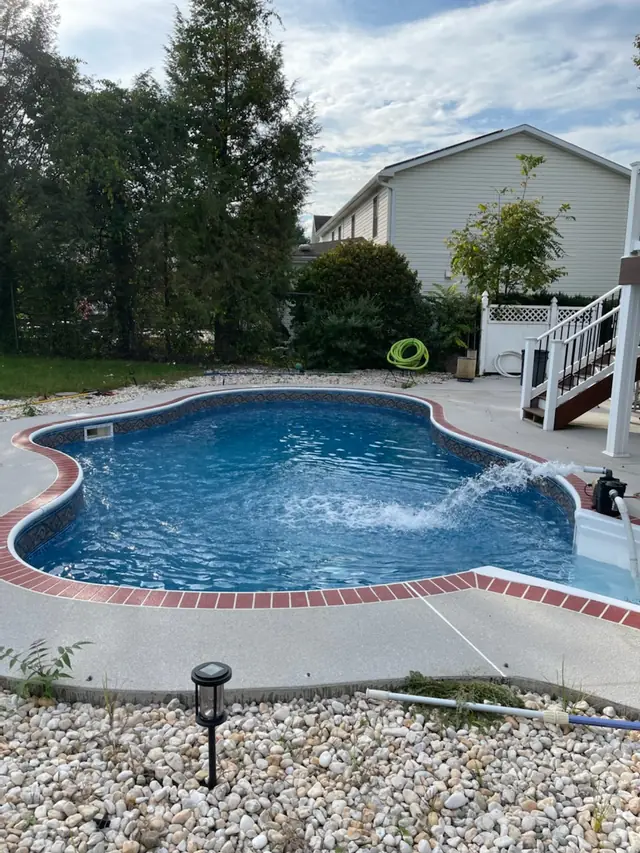 The finished pool with its new patterned liner, red brick coping and concrete deck